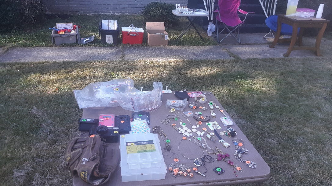 Yard sale with clothes, shoes, kitchen, jewelry, makeup, tools, mystery bags, gutter supplies.